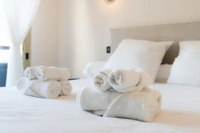 a pile of towels stacked on a bed at Magnifique appartement dans le carré d'or à Cannes in Cannes