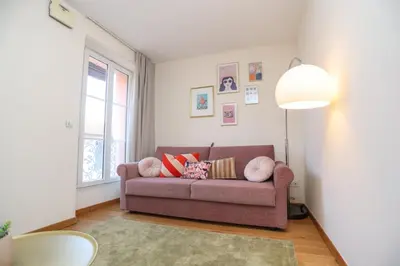 a living room with a couch and a lamp at SUITE DE LUXE PINK LADY 4P in Cannes