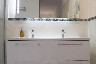 a white bathroom with two sinks and a mirror at SUITE DE LUXE PINK LADY 4P in Cannes