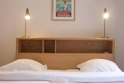 a bed with two lights on top of it at SUITE DE LUXE VERVEINE 4P in Cannes