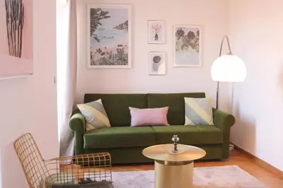 a living room with a green couch and a table at SUITE DE LUXE VERVEINE 4P in Cannes