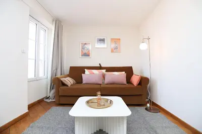 a living room with a couch and a table at SUITE DE LUXE MANDARINE 4P in Cannes