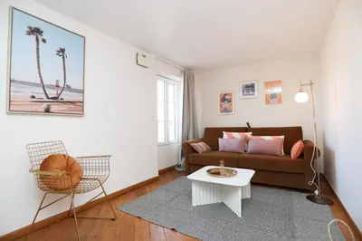 a living room with a couch and a table at SUITE DE LUXE MANDARINE 4P in Cannes
