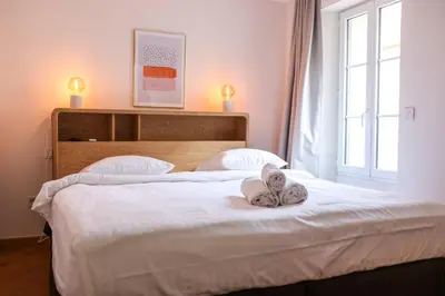 a bedroom with a bed with towels on it at SUITE DE LUXE MANDARINE 4P in Cannes