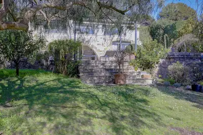 a house with a stone wall in a yard at Villa Lou Bayou French Riviera near Cannes in Vallauris