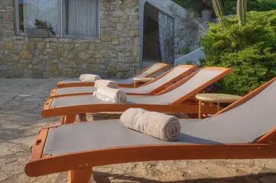 a row of lounge chairs lined up next to a building at Villa Lou Bayou French Riviera near Cannes in Vallauris