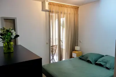 a bedroom with a bed and a vase of flowers at Quiet Appartment 400m Palais & 100m Beach in Cannes