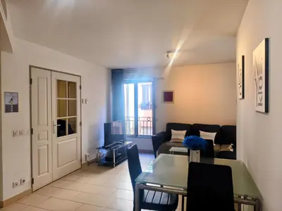 a living room with a couch and a table at Quiet Appartment 400m Palais & 100m Beach in Cannes