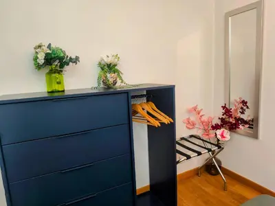 a blue dresser in a room with flowers at Quiet Appartment 400m Palais & 100m Beach in Cannes