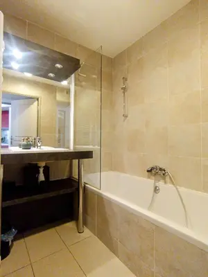 a bathroom with a bath tub and a sink at Quiet Appartment 400m Palais & 100m Beach in Cannes