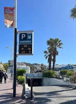a parking sign on a pole on a street at Quiet Appartment 400m Palais & 100m Beach in Cannes