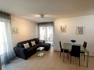 a living room with a couch and a table at Quiet Appartment 400m Palais & 100m Beach in Cannes