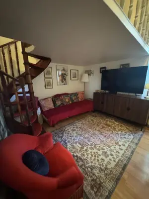 a living room with a red couch and a television at Suite Romantic in Cannes
