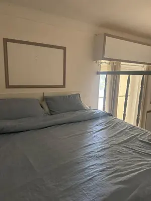a large bed in a bedroom with a large window at Suite Romantic in Cannes