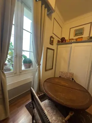 a dining room with a table and a window at Suite Romantic in Cannes