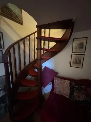 a spiral staircase in a room with a bed at Suite Romantic in Cannes