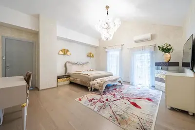 a bedroom with a bed and a chandelier at Oxford-Californie Luxury 4-Bedroom Penthouse With Parking in Cannes