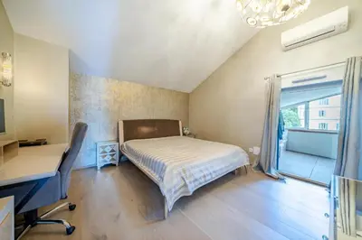 a bedroom with a bed and a desk and a window at Oxford-Californie Luxury 4-Bedroom Penthouse With Parking in Cannes