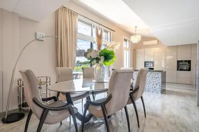 a dining room with a table and chairs at Oxford-Californie Luxury 4-Bedroom Penthouse With Parking in Cannes