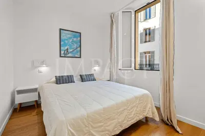 a white bedroom with a bed and a window at REF 2023- Cannes Croisette - Apartment to rent in Cannes