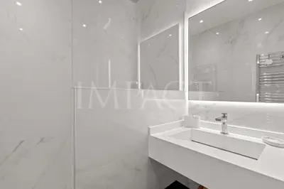 a white bathroom with a sink and a mirror at REF 2023- Cannes Croisette - Apartment to rent in Cannes
