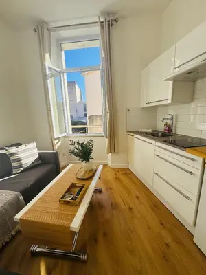 a living room with a couch and a table at Studio Design Climatisé Cœur de Cannes in Cannes