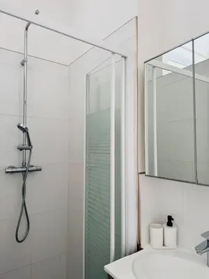 a bathroom with a glass shower and a sink at Studio Design Climatisé Cœur de Cannes in Cannes