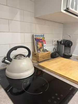 a white tea kettle sitting on top of a stove at Studio Design Climatisé Cœur de Cannes in Cannes