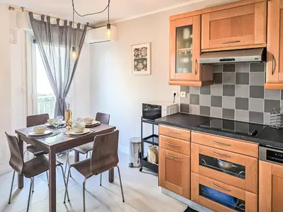 a kitchen with a table and a dining room at Apartment Reine Astrid-5 by Interhome in Cannes