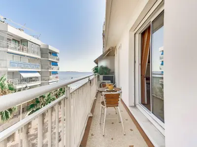 a balcony with a table and a view of the ocean at Apartment Reine Astrid-5 by Interhome in Cannes