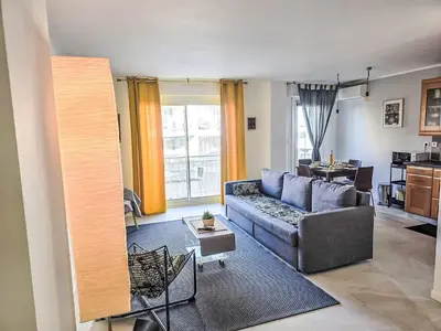 a living room with a couch and a table at Apartment Reine Astrid-5 by Interhome in Cannes