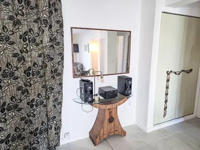a mirror and two speakers on a table in a room at Apartment Reine Astrid-5 by Interhome in Cannes