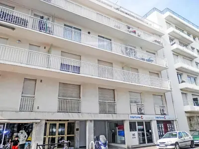 an apartment building with white balconies and a car parked in front at Apartment Reine Astrid-5 by Interhome in Cannes