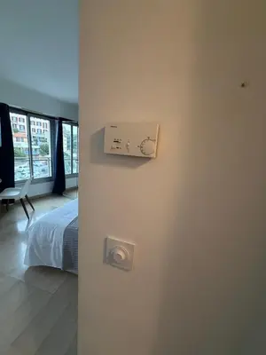 a bedroom with a bed and a lightswitch on the wall at Studio Suquet proche palais des festivals congrès in Cannes
