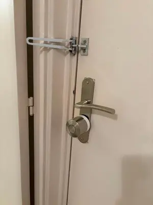 ajar door with a metal door handle on a white door at Studio Suquet proche palais des festivals congrès in Cannes