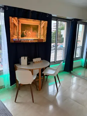a dining room with a table and two chairs at Studio Suquet proche palais des festivals congrès in Cannes