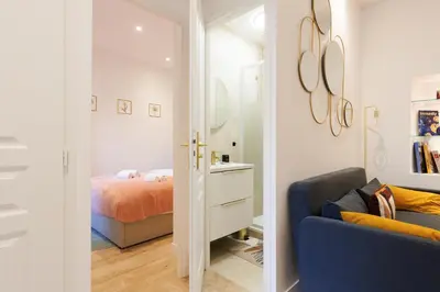 a bedroom with a bed and a blue couch at Aurea YourHostHelper in Cannes