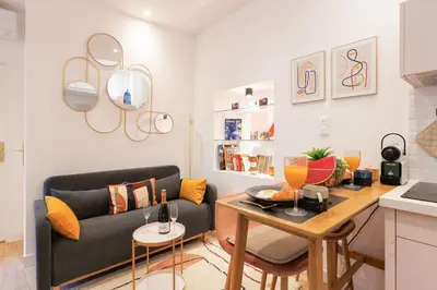 a living room with a couch and a table at Aurea YourHostHelper in Cannes