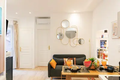 a living room with a couch and a table at Aurea YourHostHelper in Cannes