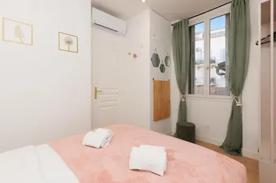 a bedroom with a bed with two towels on it at Aurea YourHostHelper in Cannes