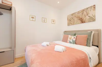 a bedroom with a large bed with towels on it at Aurea YourHostHelper in Cannes
