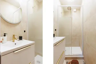 a white bathroom with a sink and a shower at Aurea YourHostHelper in Cannes