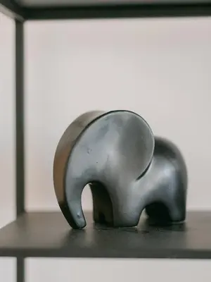 a metal elephant statue sitting on top of a table at Le Venus in Cannes