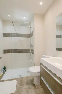 a bathroom with a toilet and a shower and a sink at Le Venus in Cannes