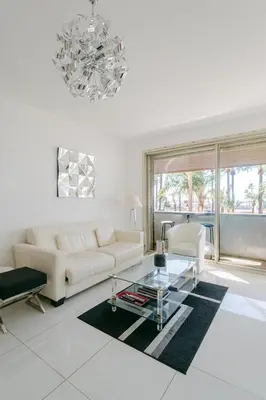 a living room with a couch and a glass table at Le Venus in Cannes
