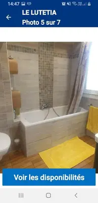 a bathroom with a white bath tub and a toilet at Le lutetia in Cannes