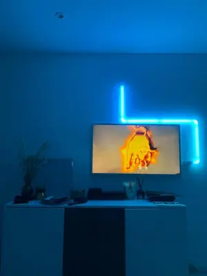 a computer monitor in a room with a blue light at Appartement luxe Jaccuzi marbre et terrasse in Cannes