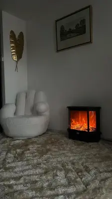 a living room with a couch and a fireplace at Appartement luxe Jaccuzi marbre et terrasse in Cannes