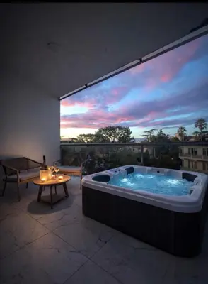 a jacuzzi tub on a balcony with a view at Appartement luxe Jaccuzi marbre et terrasse in Cannes