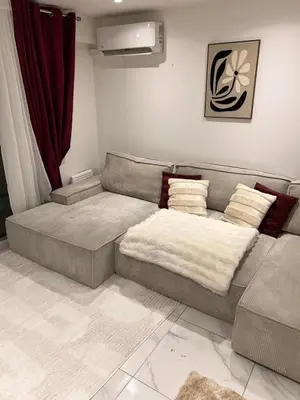 a living room with a couch with pillows at Appartement luxe Jaccuzi marbre et terrasse in Cannes